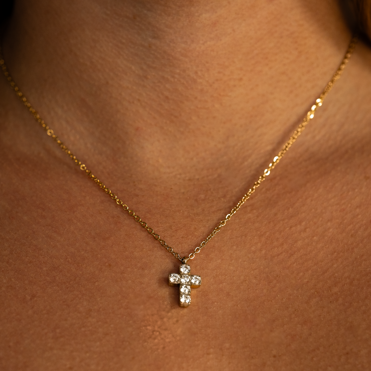 Women wearing small gold cross necklace stainless steel chain Christian jewelry 